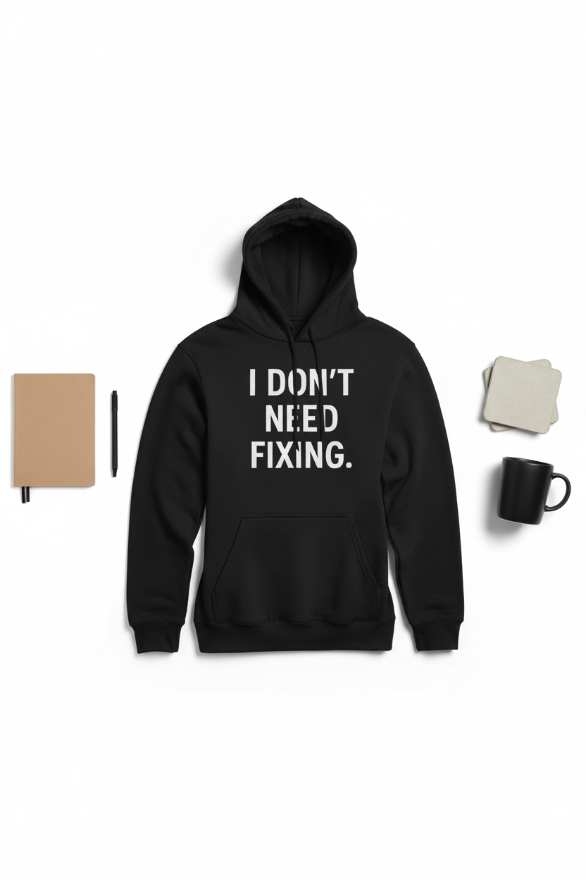 Flat lay of I Don't Need Fixing black neurodivergent hoodie