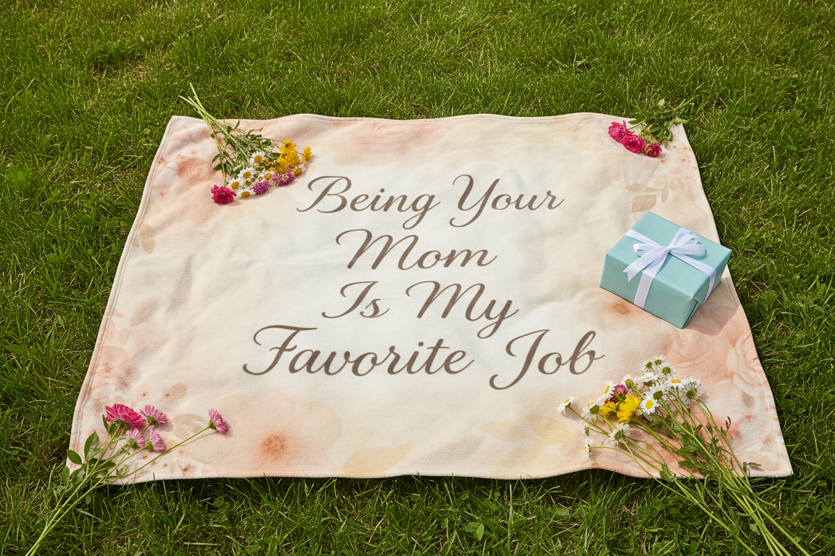 Blanket laid out on grass for picnic with flowers
