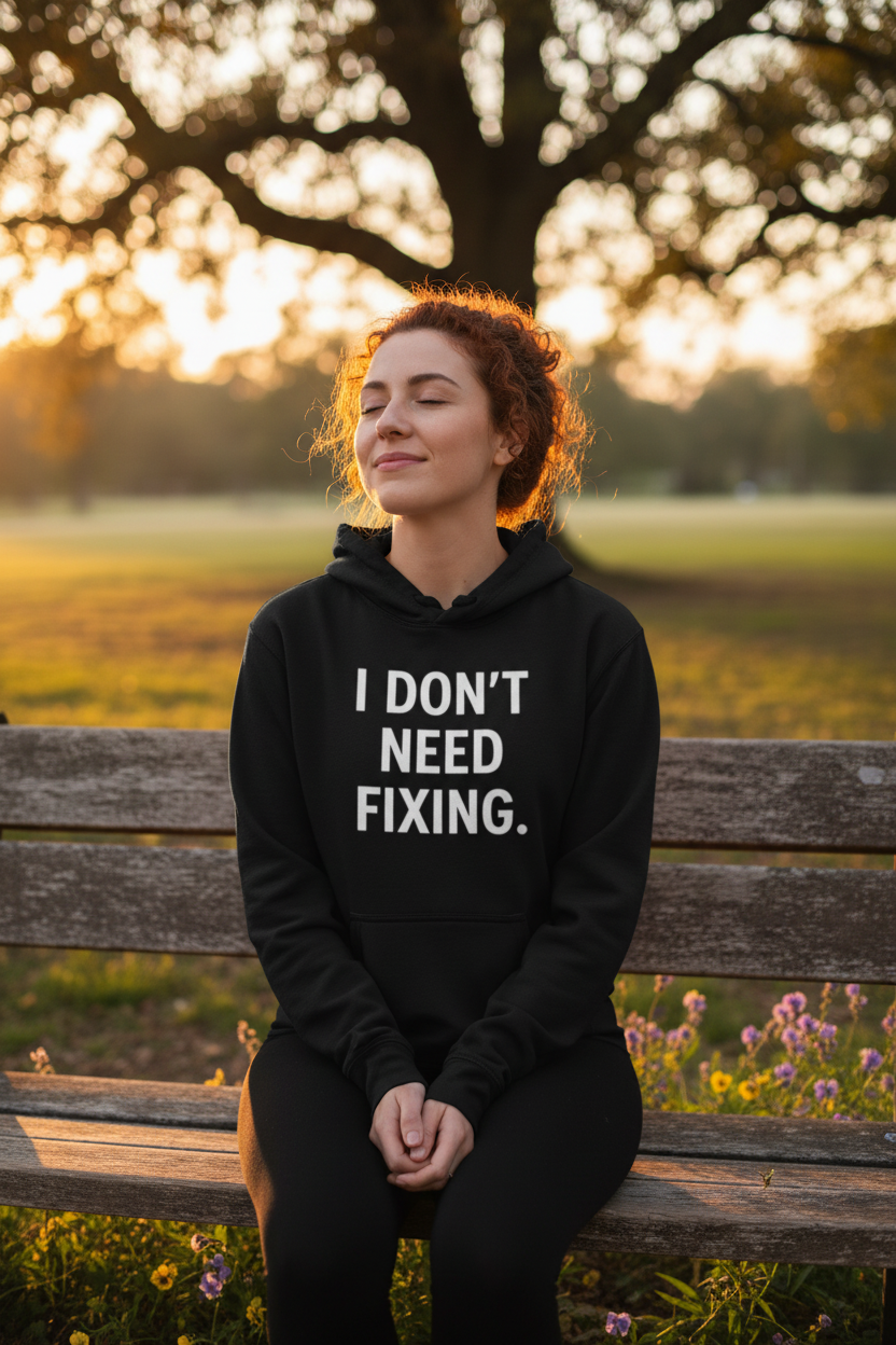 Woman outdoors wearing I Don't Need Fixing black hoodie