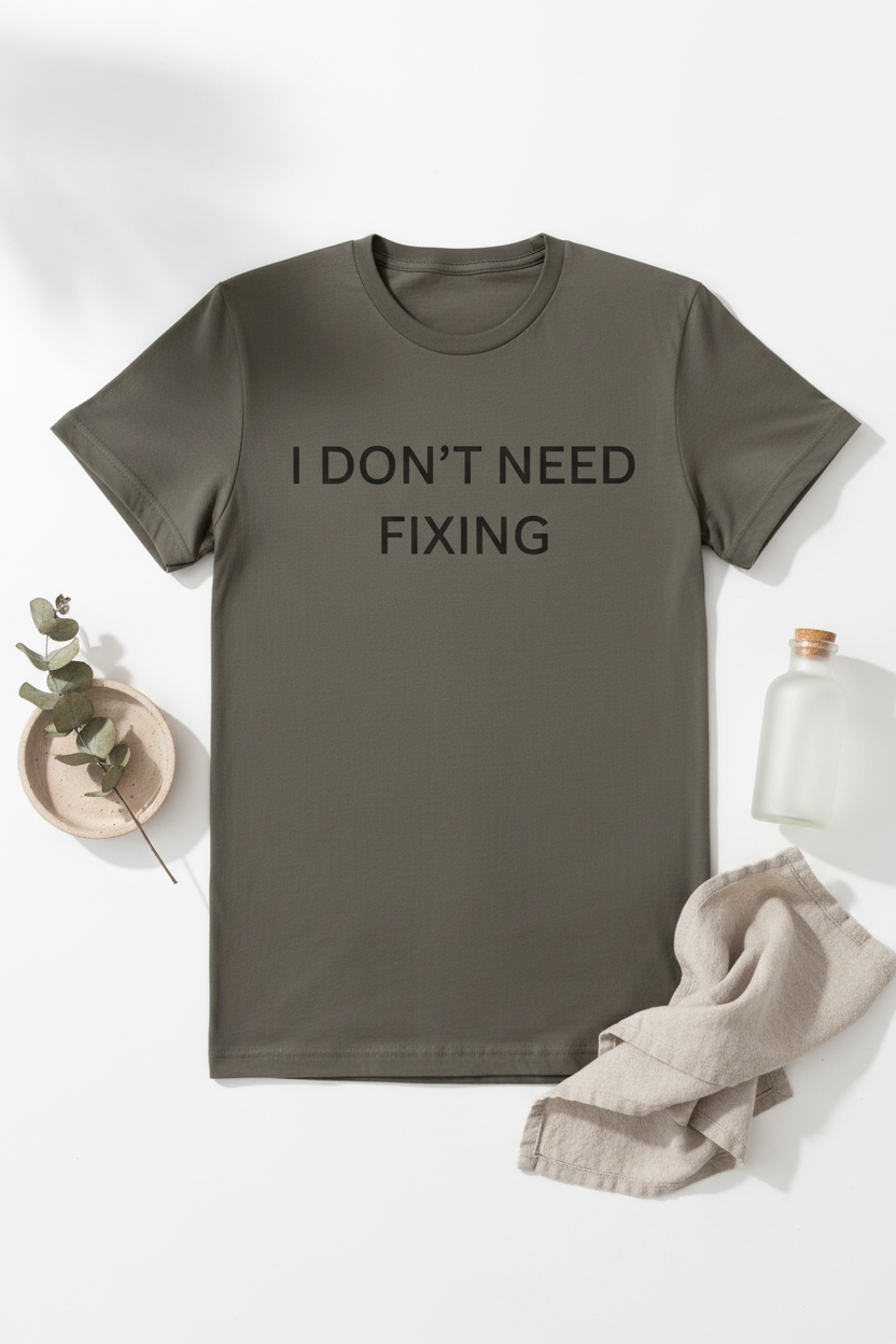 Flat lay of I Don't Need Fixing neurodivergent tee