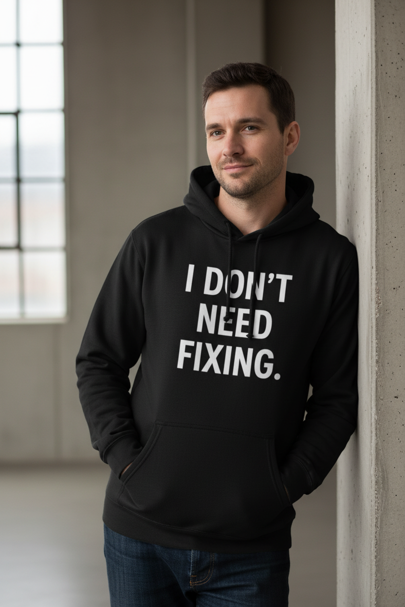 Man wearing I Don't Need Fixing black neurodivergent hoodie